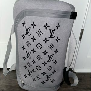 Gray Authentic Louis Vuitton soft duffle luggage.